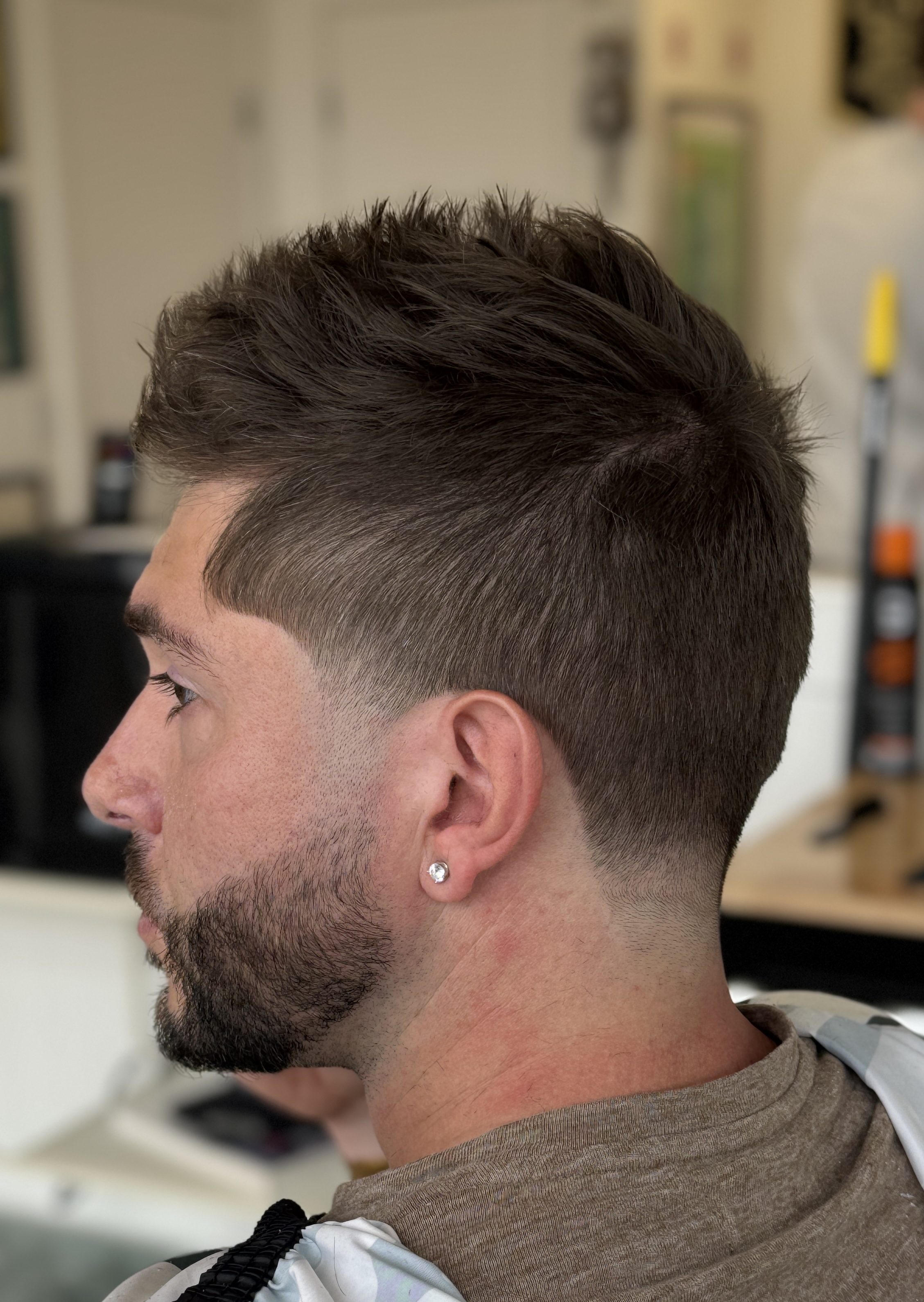 Fresh fade with clean lineup and textured top styling
